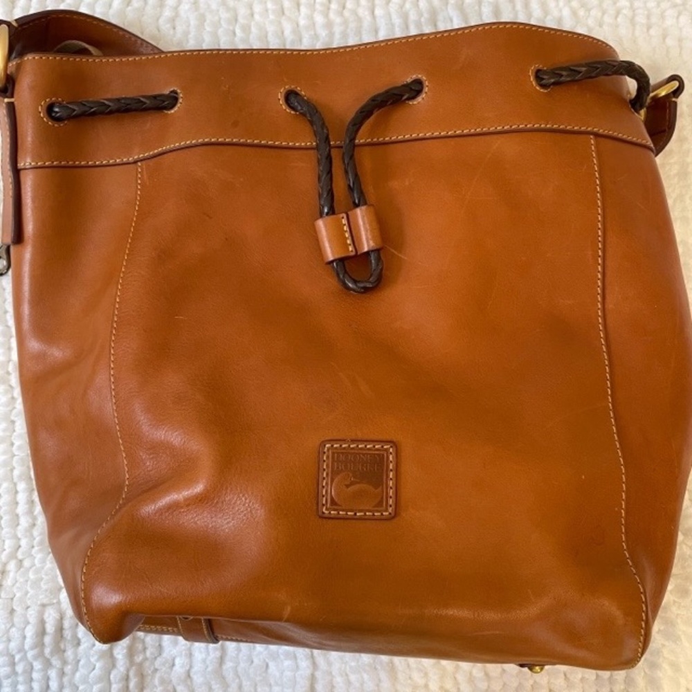 Dooney & Bourke tan leather bucket bag w/ braided leather draw closure
